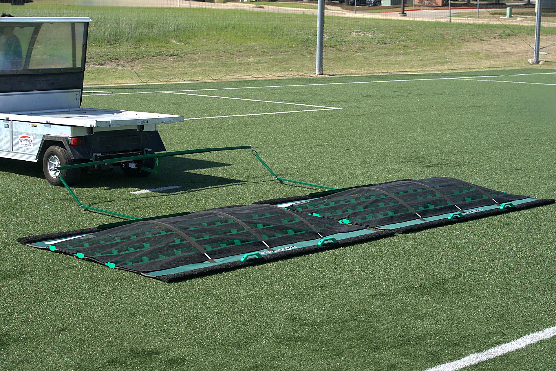 Duplex SportSweeper™ towed wide angle on field